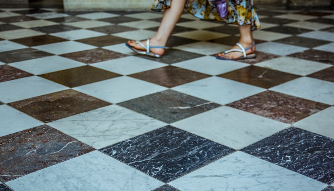 person walking on checked tiles
